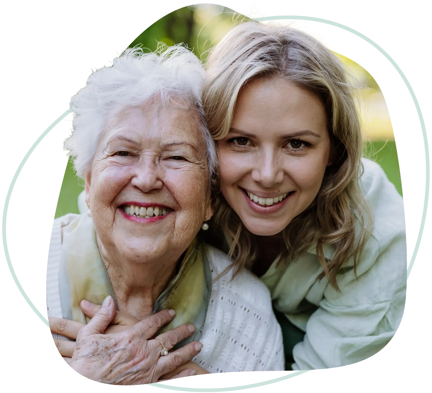 A smiling older woman and her Goldy Enrichment Specialist cheek to cheek outdoors