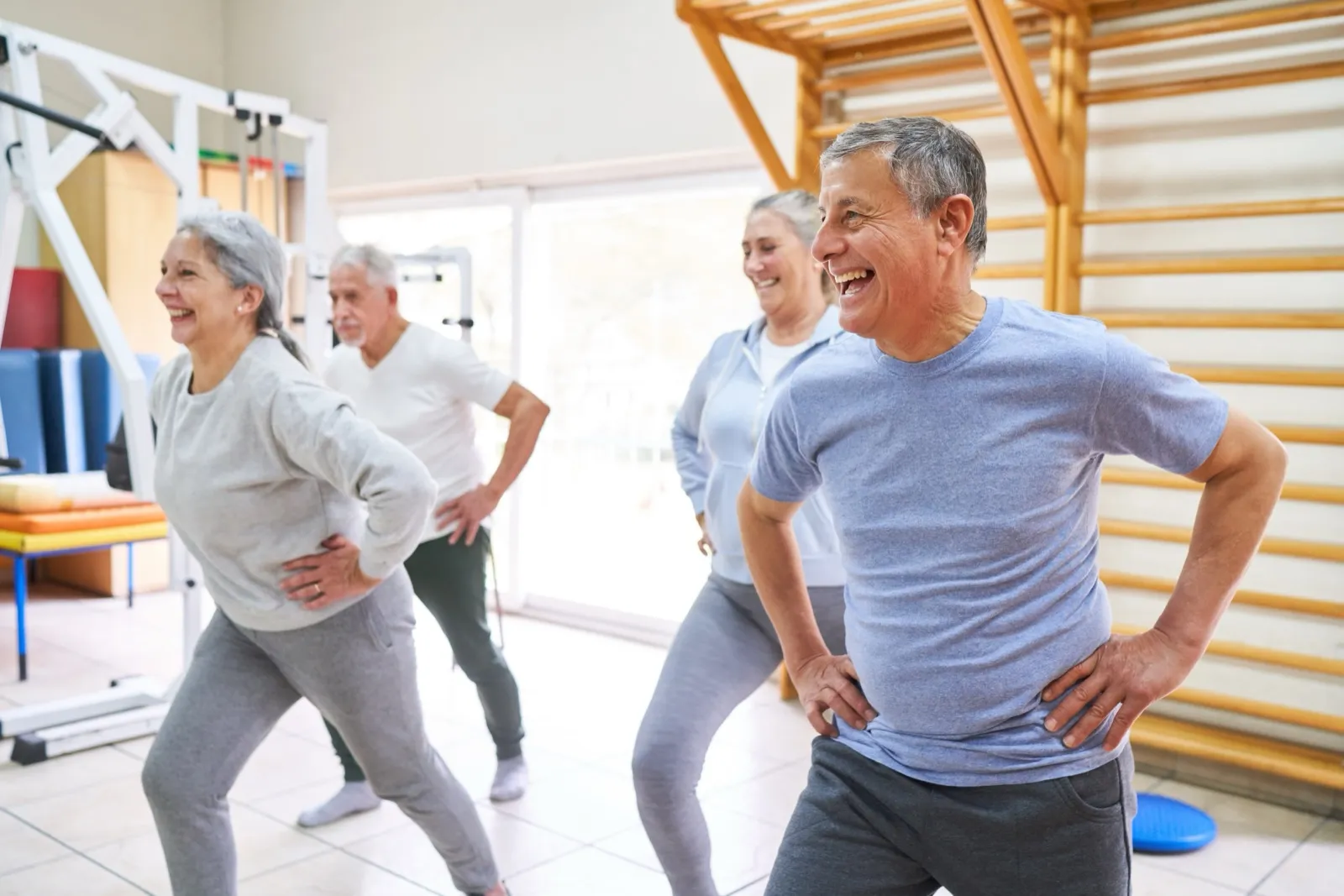 Older adults laughing together in a group exercise class